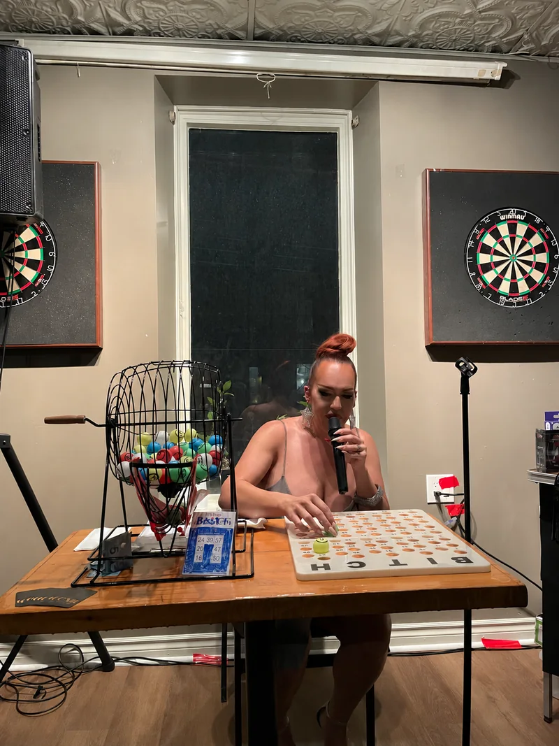 Kenadie St. James with the bingo board and microphone