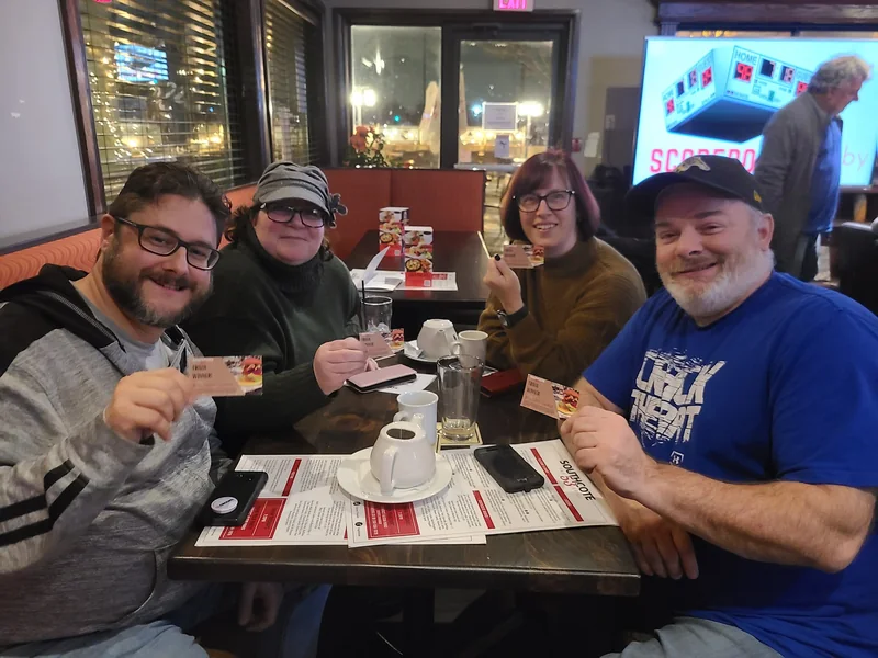 A trivia team gathered around their answer sheets