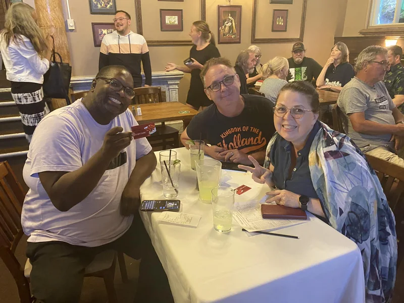 Three trivia guests enjoying a night together